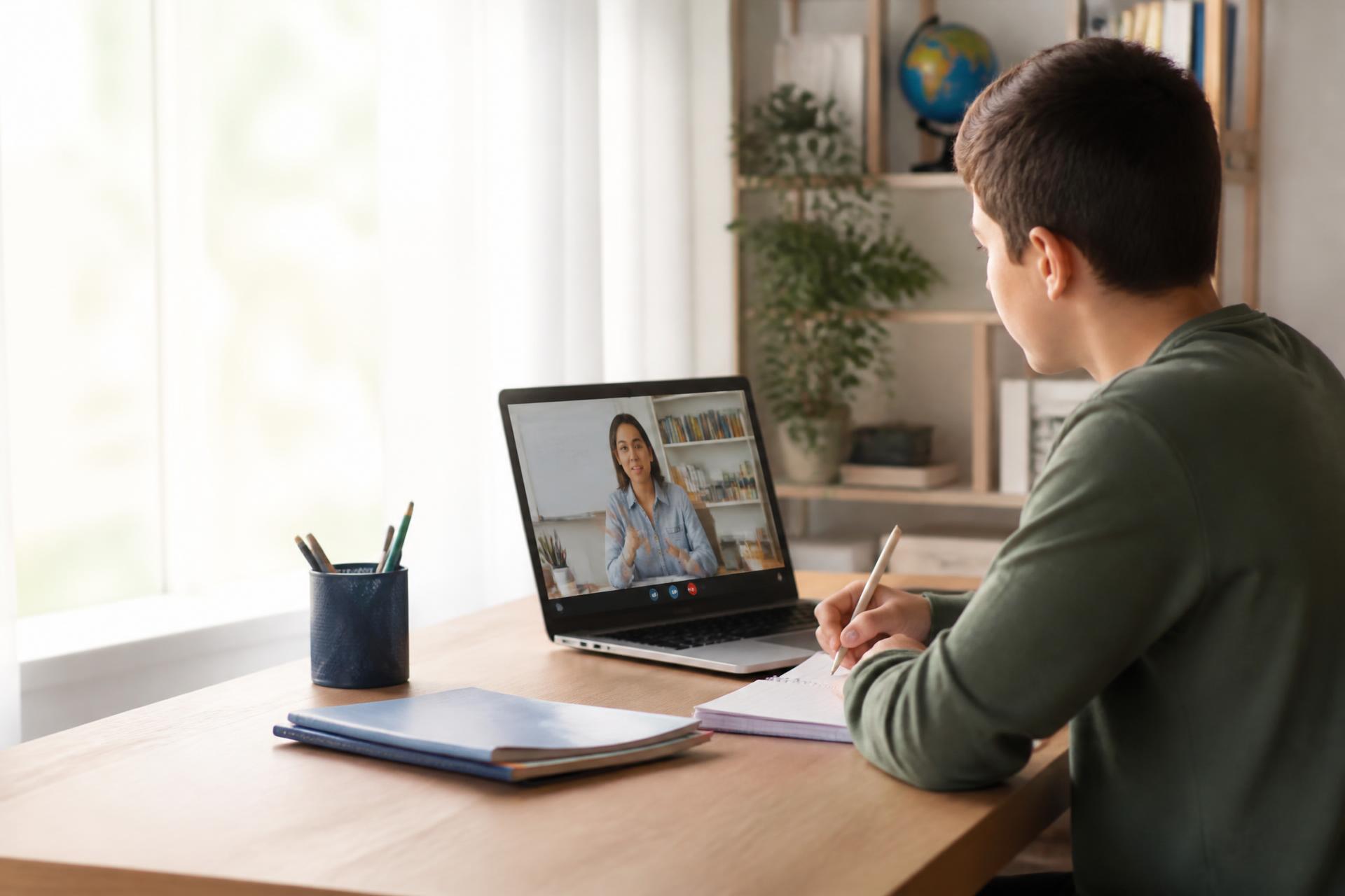Student attending a one-on-one online tutoring lesson at a home desk
